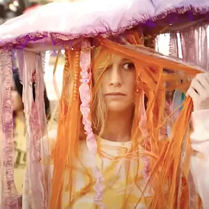 A woman wears a strange hat in 'The Marvels.'