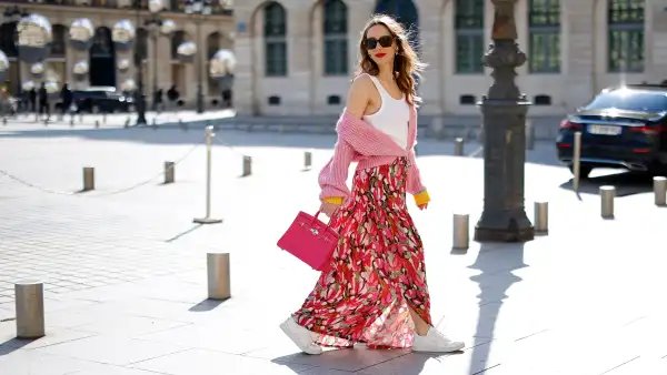 PARIS, FRANCE - FEBRUARY 28: Alexandra Lapp is seen wearing CAMOUFLAGE COUTURE skirt and knit, CELINE tank top, CELINE trainer low lace-up sneaker, CHANEL sunglasses, HERMES mini Birkin bag in pink during a street style shoot on February 28, 2023 in Paris, France. (Photo by Streetstyleshooters/Getty Images)