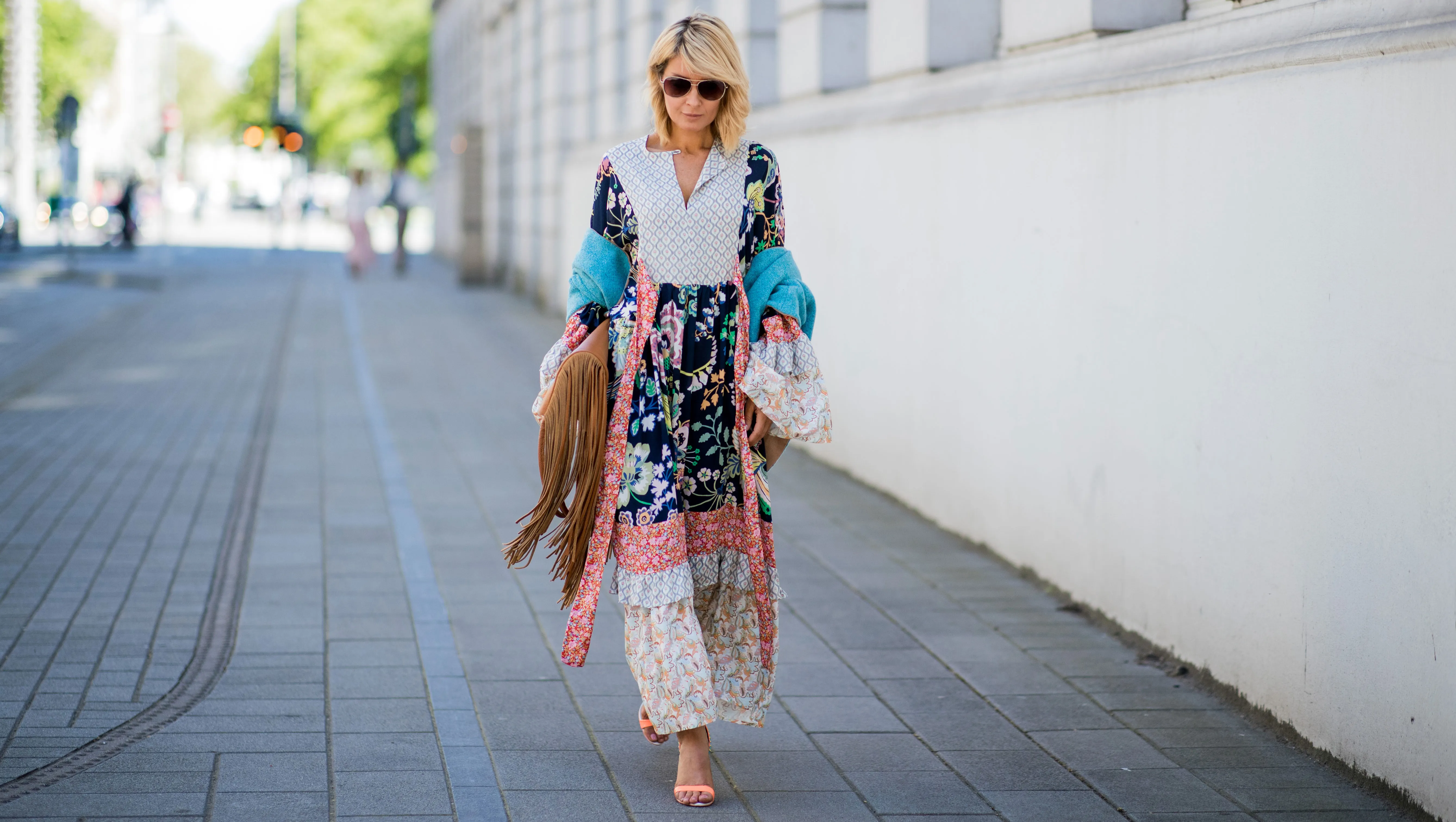 DUESSELDORF, GERMANY - MAY 05: Gitta Banko wearing a long Boho dress by Perseverance London, turquoise turn-over half-sleeve scarf by Blondwalk 4 a cuckoo moment, multi-colored strappy open-toe sandals by Sophia Webster, cognac-colored fringed oversize leather bag by Amma Mode, and sunglasses by Michael Kors on May 5, 2018 in Duesseldorf, Germany. (Photo by Christian Vierig/Getty Images)