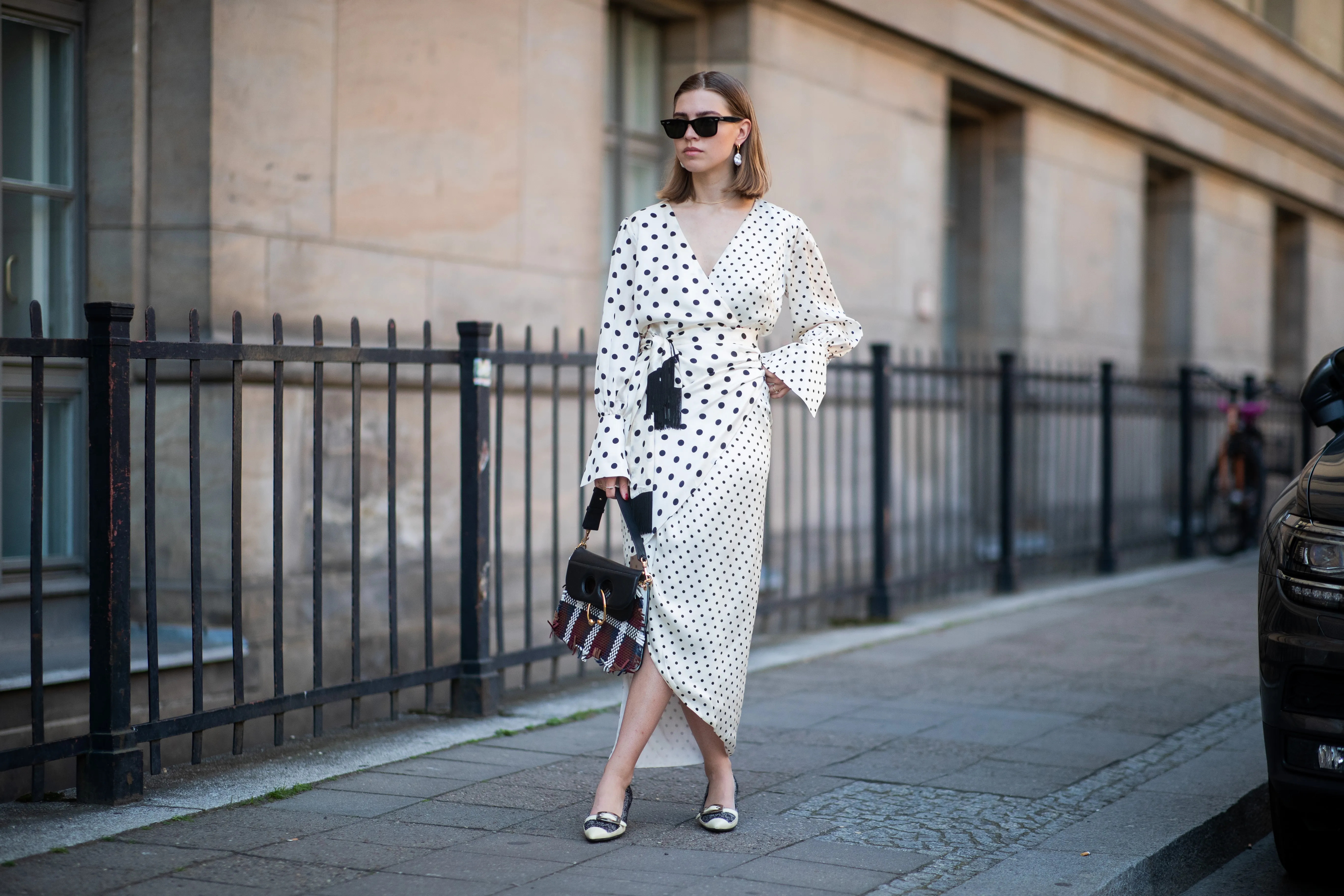 Swantje S&ouml;mmer is seen wearing white dress with black dots print Mother of Pearl, JW Anderson plaid bag, Prada shoes in black and white, Ray Ban sunglasses on June 05, 2019 in Berlin, Germany.