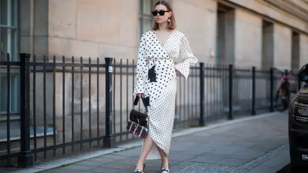 Swantje Sömmer is seen wearing white dress with black dots print Mother of Pearl, JW Anderson plaid bag, Prada shoes in black and white, Ray Ban sunglasses on June 05, 2019 in Berlin, Germany.