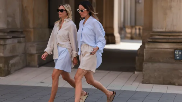 Anne Philine (L) seen wearing black Celine sunglasses, a creme beige shirt from SohoStudios, light blue SohoStudios shorts and creme white suede Birkenstock Arizona sandals; Elise Seitz (R) seen wearing white Celine sunglasses, a light blue SohoStudios shirt, a creme beige shorts from SohoStudios and beige suede Birkenstock Boston sandals, on August 16, 2022 in Hamburg, Germany.