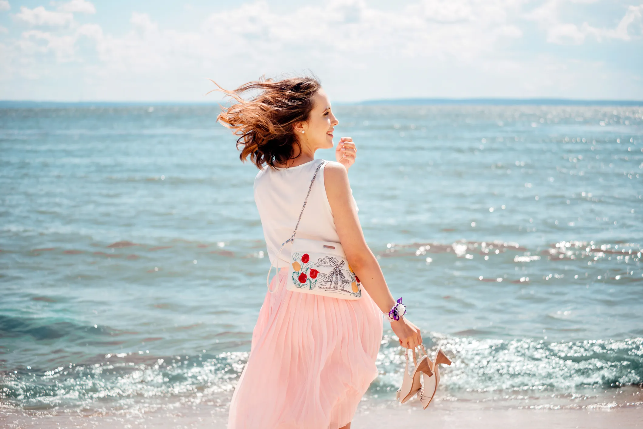 Young pretty woman with blowing skirt, pastel colors: pink and blue