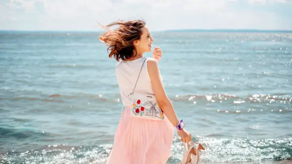 Young pretty woman with blowing skirt, pastel colors: pink and blue