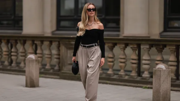 HAMBURG, GERMANY - AUGUST 29: Isabelle Hartmann is seen wearing Bottega Veneta mini Jodie black leather bag, Saint Laurent black silver heels, Edited x Isabelle Hartmann wide leg beige pants, Filippa K black silver leather belt, Khaite black off shoulder top, Tiffany & Co City Hardwear silver chain and Saint Laurent black shades on August 29, 2022 in Hamburg, Germany. (Photo by Jeremy Moeller/Getty Images)