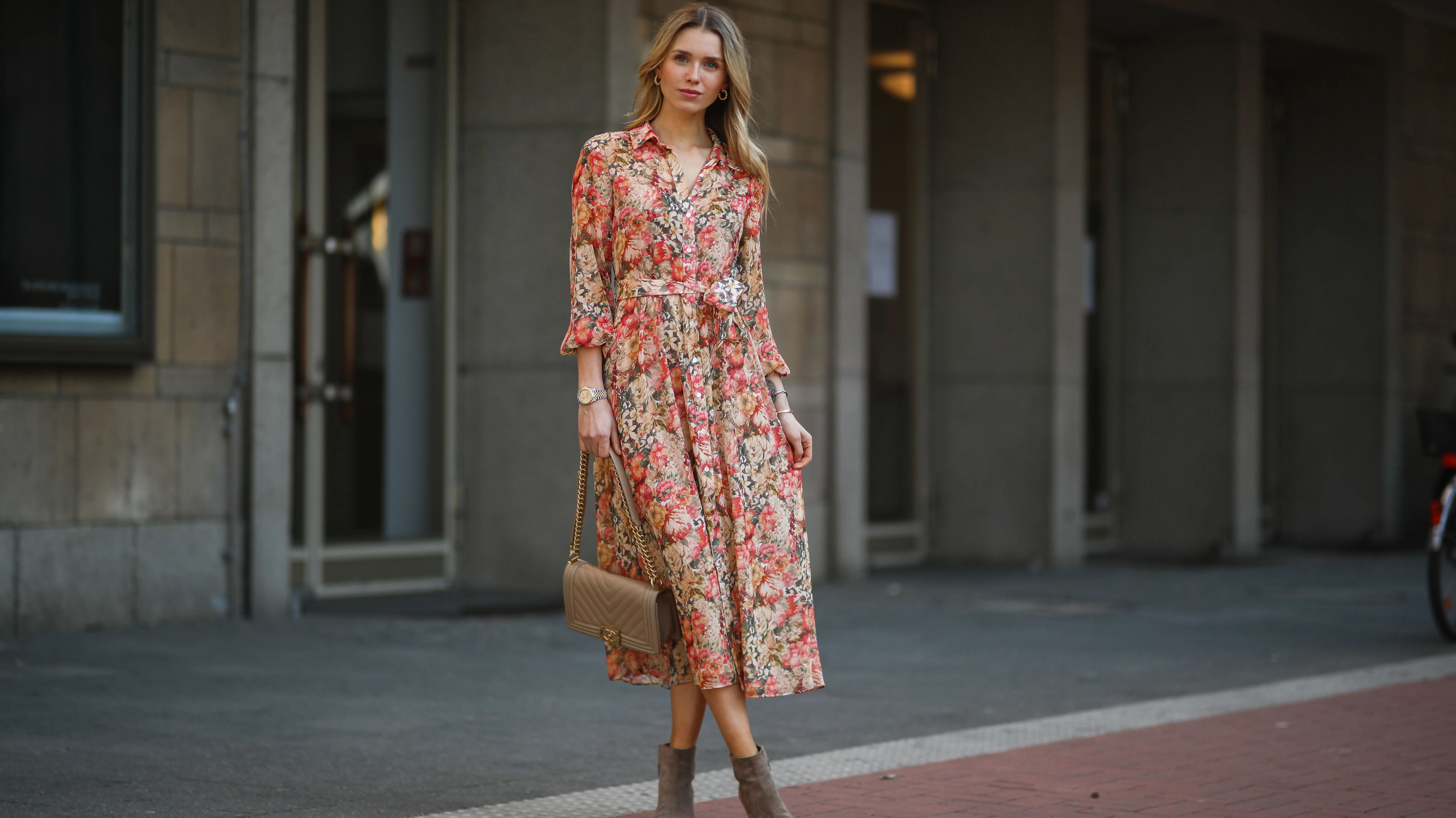 DUSSELDORF, GERMANY - MARCH 24: Scarlett Gartmann wearing Mango flower dress, beige Chanel Boy bag and brown Kennel & Schmenger leather boots on March 24, 2021 in Dusseldorf, Germany. (Photo by Jeremy Moeller/Getty Images)