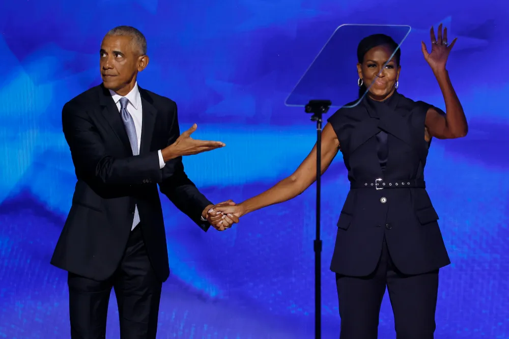 CHICAGO, ILLINOIS - AUGUST 20: Former U.S. President Barack Obama (L) greets former first lady Michelle Obama as he arrives to speak on stage during the second day of the Democratic National Convention at the United Center on August 20, 2024 in Chicago, Illinois. Delegates, politicians, and Democratic Party supporters are gathering in Chicago, as current Vice President Kamala Harris is named her party's presidential nominee. The DNC takes place from August 19-22. (Photo by Chip Somodevilla/Getty Images)