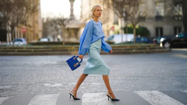PARIS, FRANCE - JANUARY 21: Leonie Hanne wears a blue silky lustous blouse with puff sleeves, a blue quilted Lady Dior bag, a pale blue leather skirt, Dior pointy shoes, during Paris Fashion Week - Haute Couture Spring/Summer 2020, on January 21, 2020 in Paris, France. (Photo by Edward Berthelot/Getty Images )