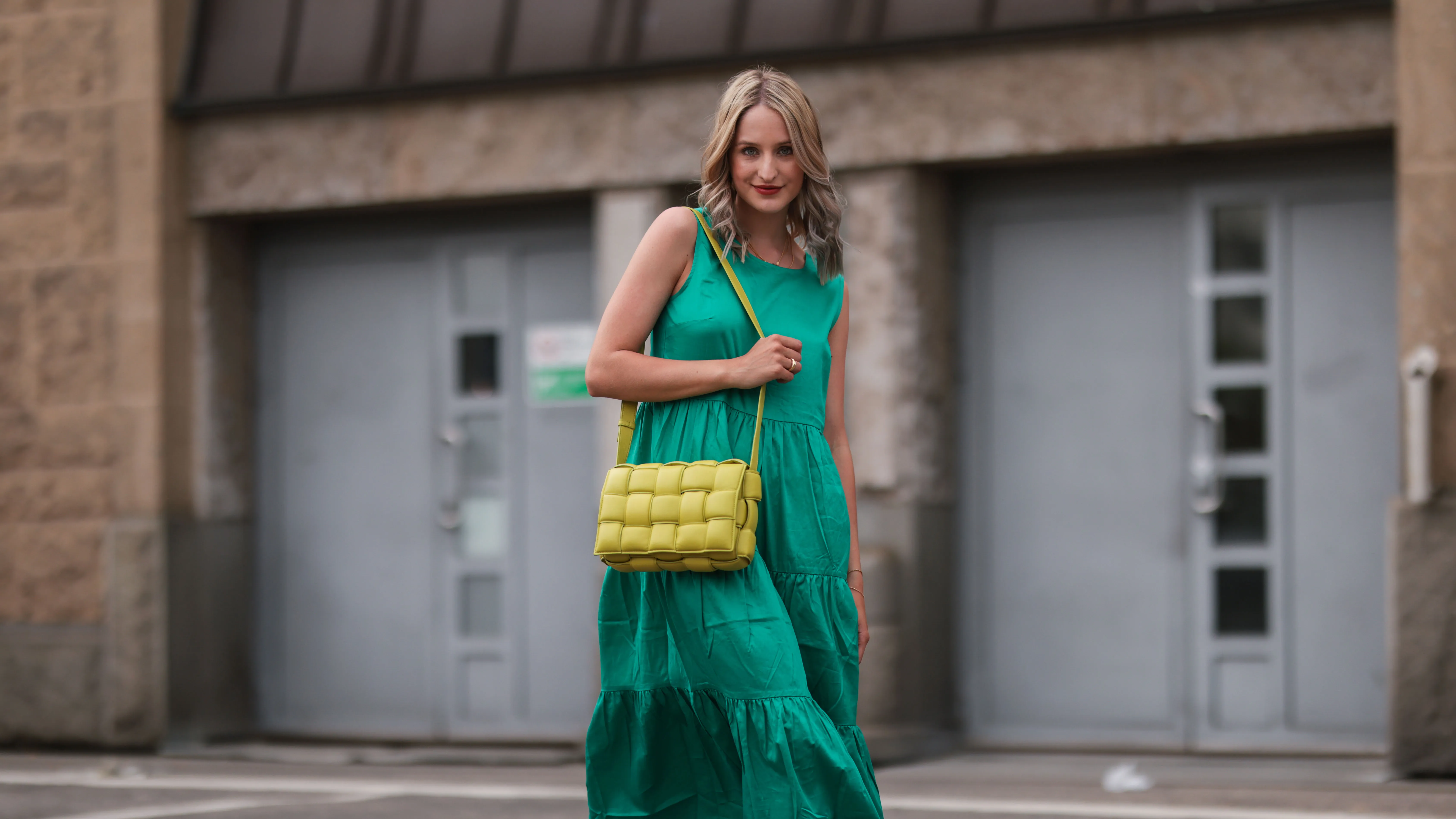 HAMBURG, GERMANY - JUNE 03: Louisa Theresa Grass wearing green Zero Fashion midi dress, yellow Bottega Veneta leather bag and white Hermes slides on June 03, 2021 in Hamburg, Germany. (Photo by Jeremy Moeller/Getty Images)