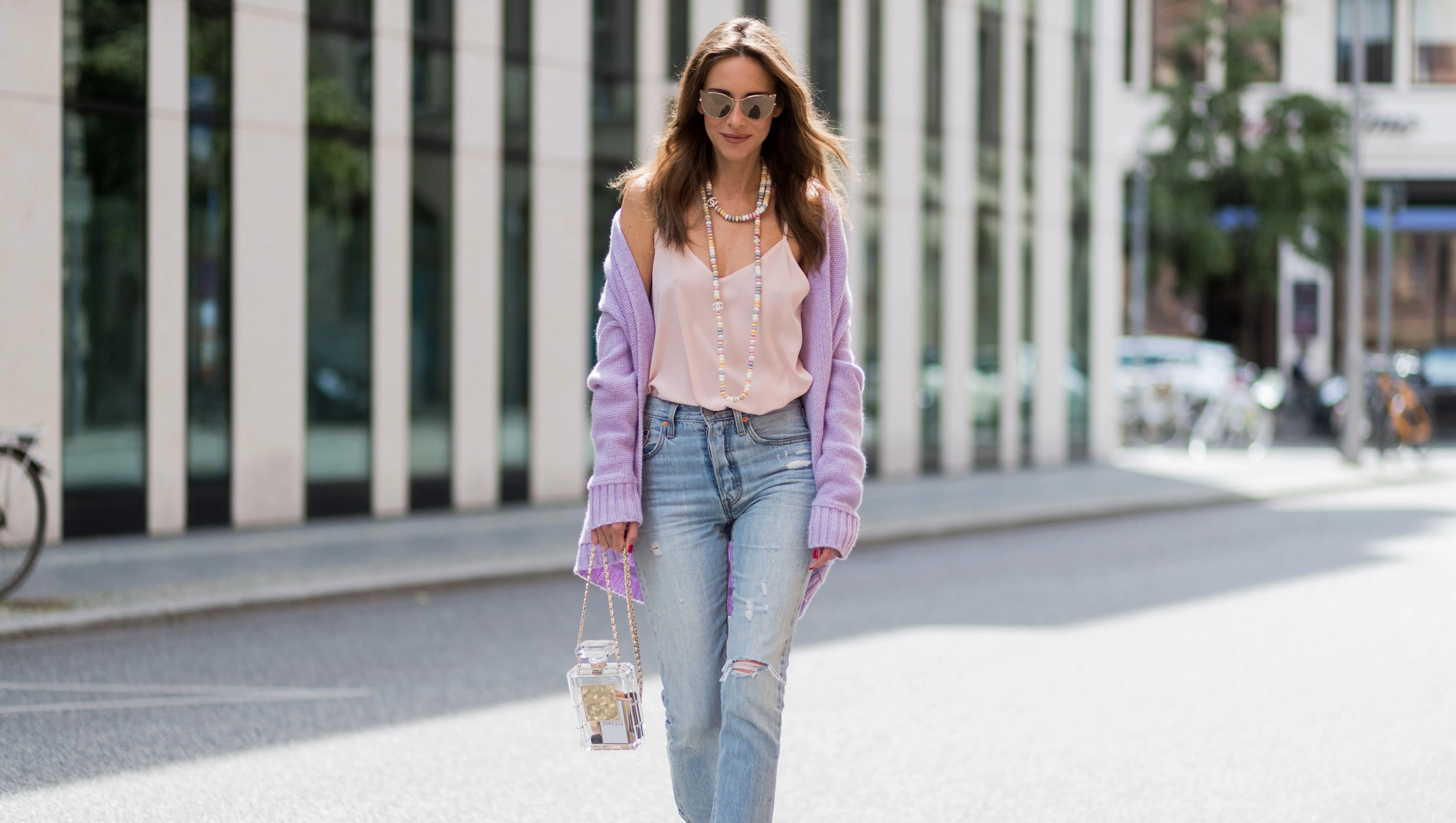 BERLIN, GERMANY - JULY 07: Alexandra Lapp wearing a purple cashmere cardigan by Heartbreaker, a rose tank top in silk from Jadicted, a high waist, non-strech denim, five-pocket 501 skinny jeans from Levis, a candy necklace from Chanel supermarket collection in pastel tones, a Chanel perfume bottle bag in plexiglass and a golden chain with white leather, Christian Louboutin pumps Feerica with nude mesh upper embedded with a Swarovski crystal degrade and Karl Lagerfeld cat-eye sunglasses in the shape of cat ears during the Mercedes-Benz Fashion Week Berlin Spring/Summer 2018 on July 7, 2017 in Berlin, Germany. (Photo by Christian Vierig/Getty Images)