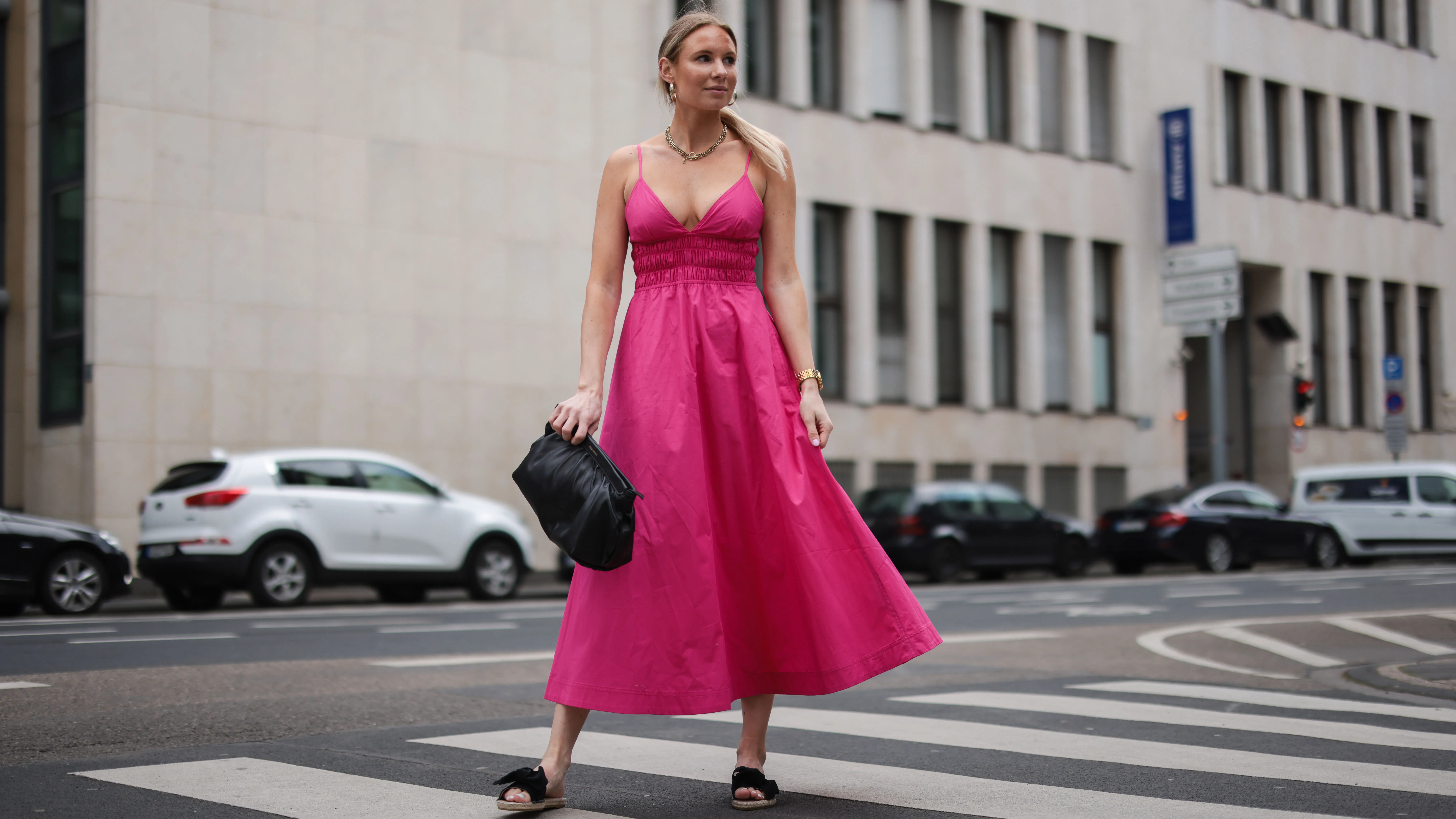 COLOGNE, GERMANY - MAY 12: Sarah Achterholt wearing pink Zara dress, black Isabel Marant pouch bag and black Manebi slides via The Wants Shoes on May 12, 2021 in Cologne, Germany. (Photo by Jeremy Moeller/Getty Images)