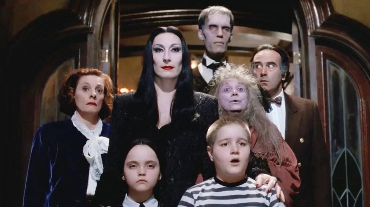 A kooky family stands in a doorway in 'The Addams Family.'