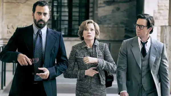 Three people walk in 'All the Money in the World.'