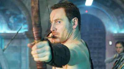 A man aims a bow and arrow in 'Assassin's Creed.'