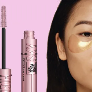 Crop half face closeup studio shot of young Asian woman with collagen patches under eyes looking at camera, copy space