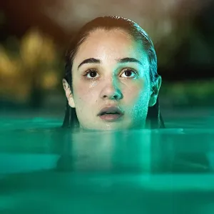 A girl look up in a pool in 'Bad Influence.'