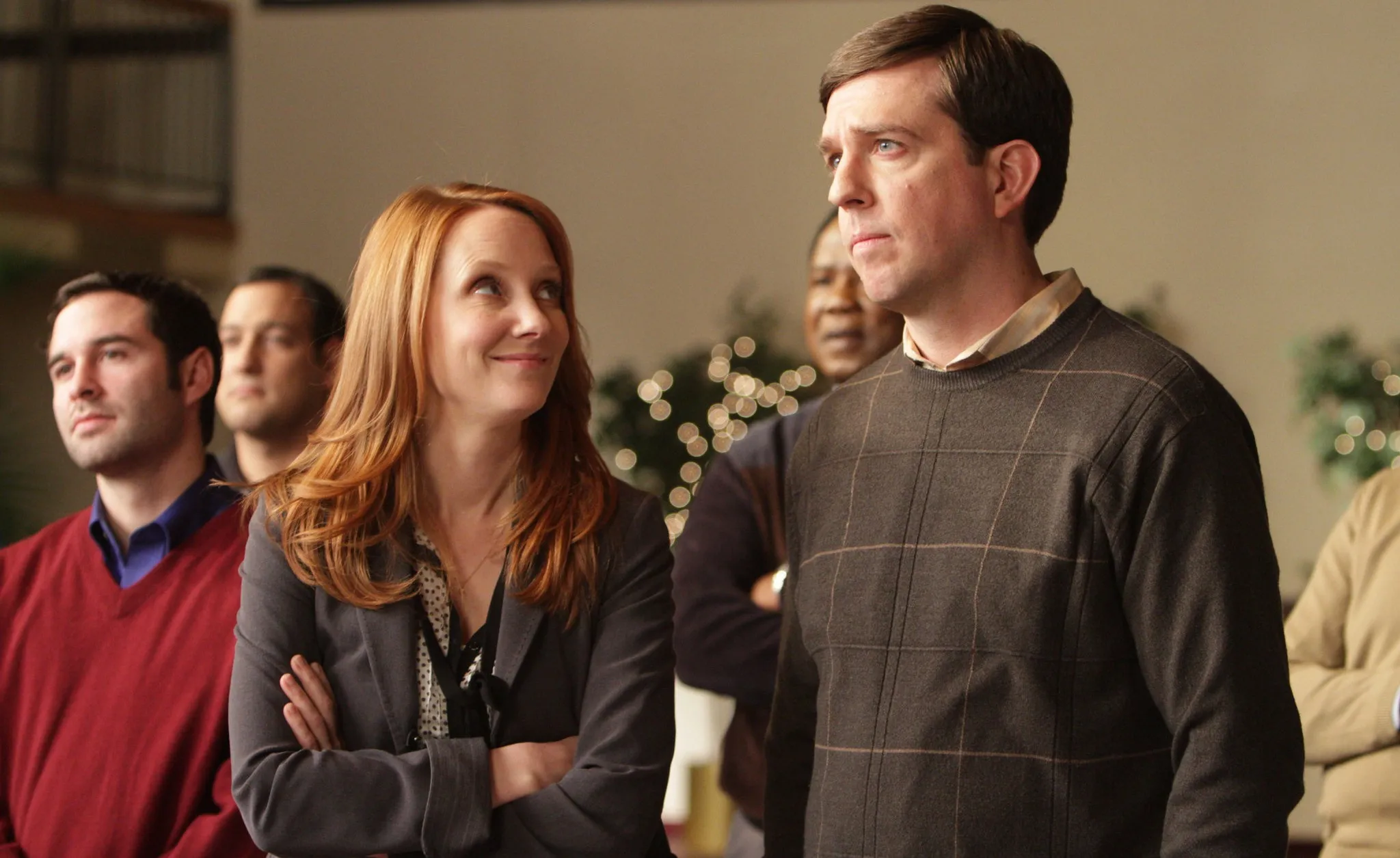 A woman looks up at a man in 'Cedar Rapids.'