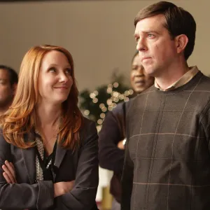 A woman looks up at a man in 'Cedar Rapids.'