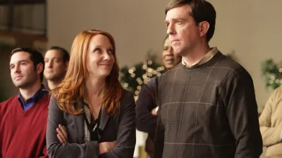 A woman looks up at a man in 'Cedar Rapids.'