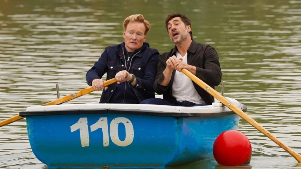 Two men row a boat in a lake in 'Conan O'Brien Must Go.'