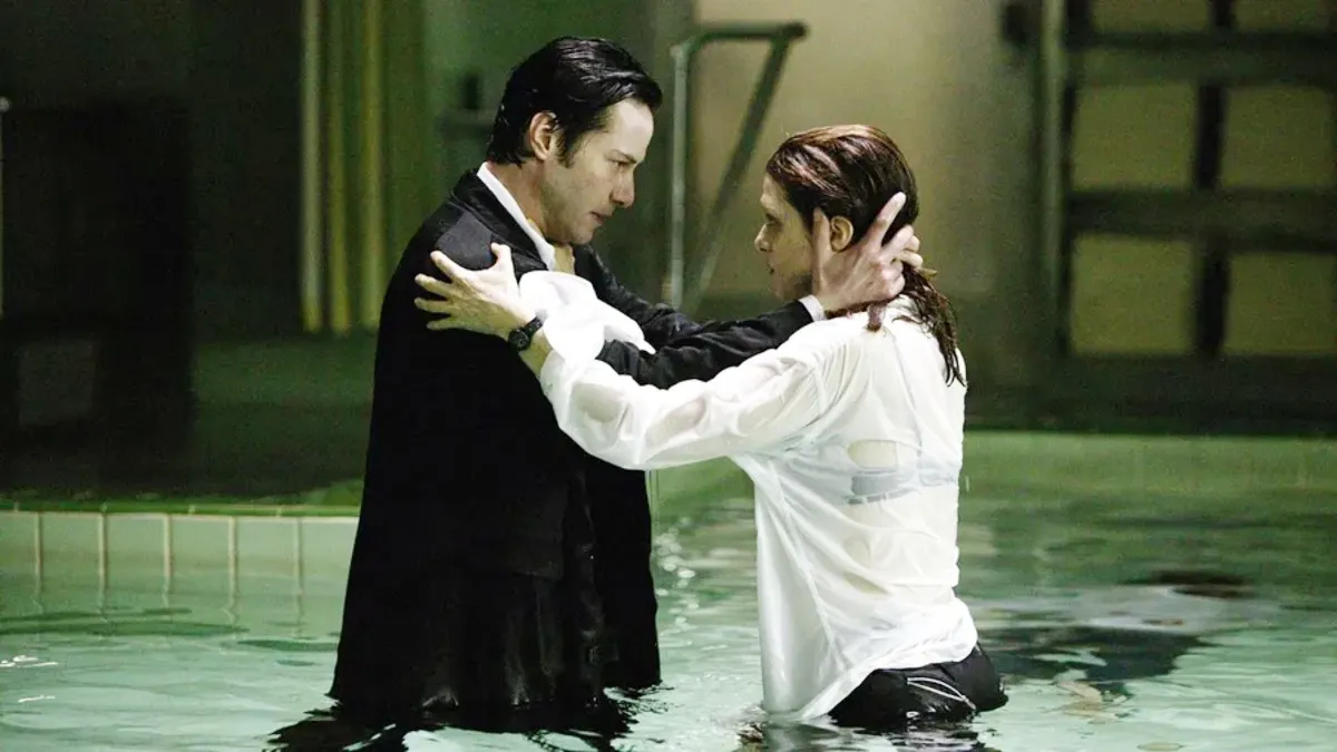 A man holds a woman in a pool in 'Constantine.'