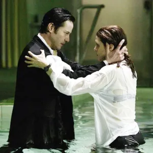 A man holds a woman in a pool in 'Constantine.'
