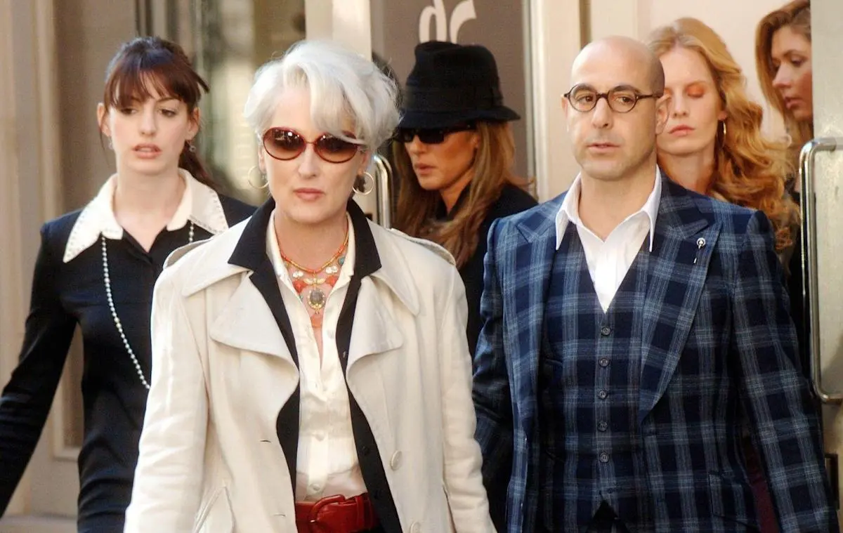 Three people exit a building in 'The Devil Wears Prada.'