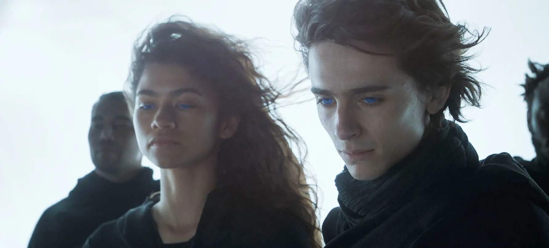 A man and a woman look down in 'Dune.'