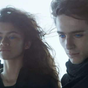 A man and a woman look down in 'Dune.'