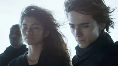 A man and a woman look down in 'Dune.'