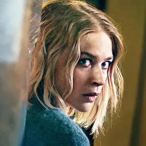 A blonde woman looks over her shoulder in 'Exterritorial.'