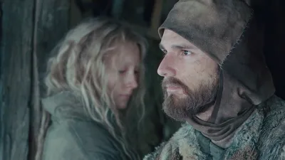 A man and a girl look in opposite directions in 'Hanna.'