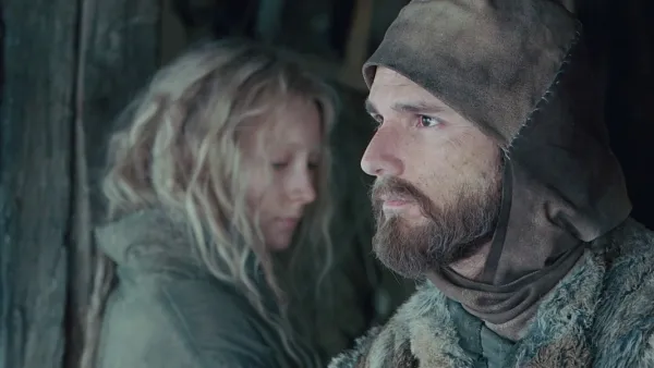 A man and a girl look in opposite directions in 'Hanna.'