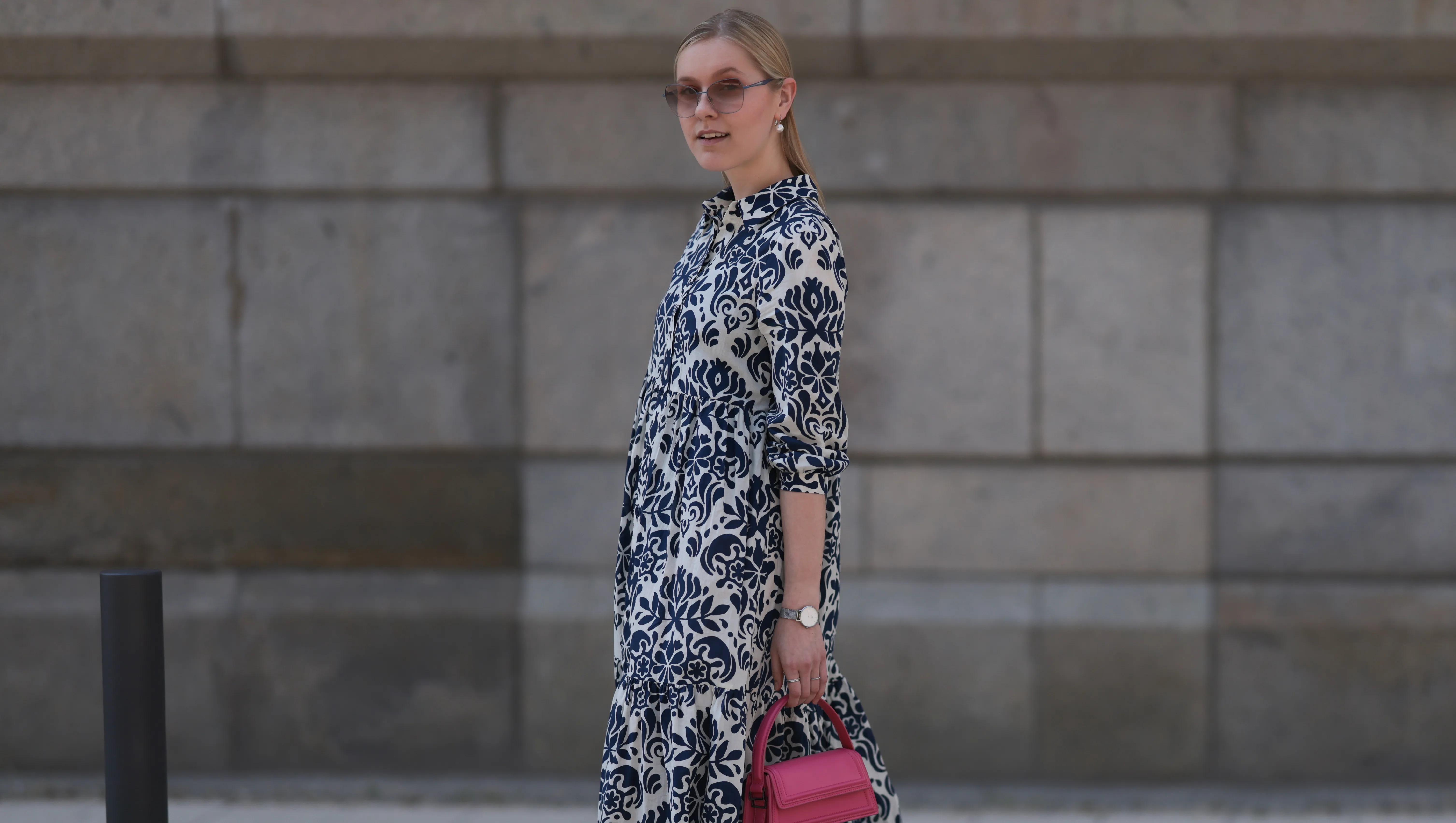 HAMBURG, GERMANY - JUNE 08: Lil Paulin seen wearing a darkblue and white flower printed long dress, pink mini handbag, Emporio Armani brown big shades, Daniel Wellington silver watch, Superga navy blue sneaker and silver pearls earrings and rings on June 08, 2023 in Hamburg, Germany. (Photo by Jeremy Moeller/Getty Images)