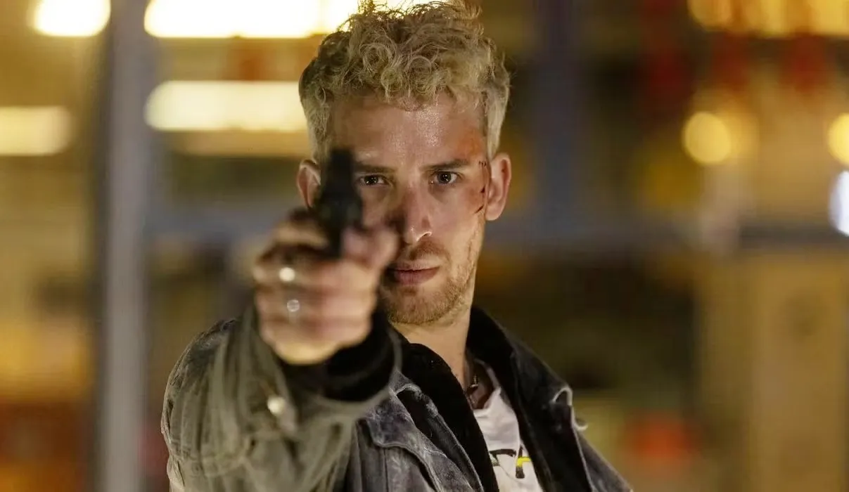 A man aims a gun at the screen in 'Night Call.'