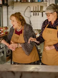 Four older women stand in a kitchen in 'Nonnas.'