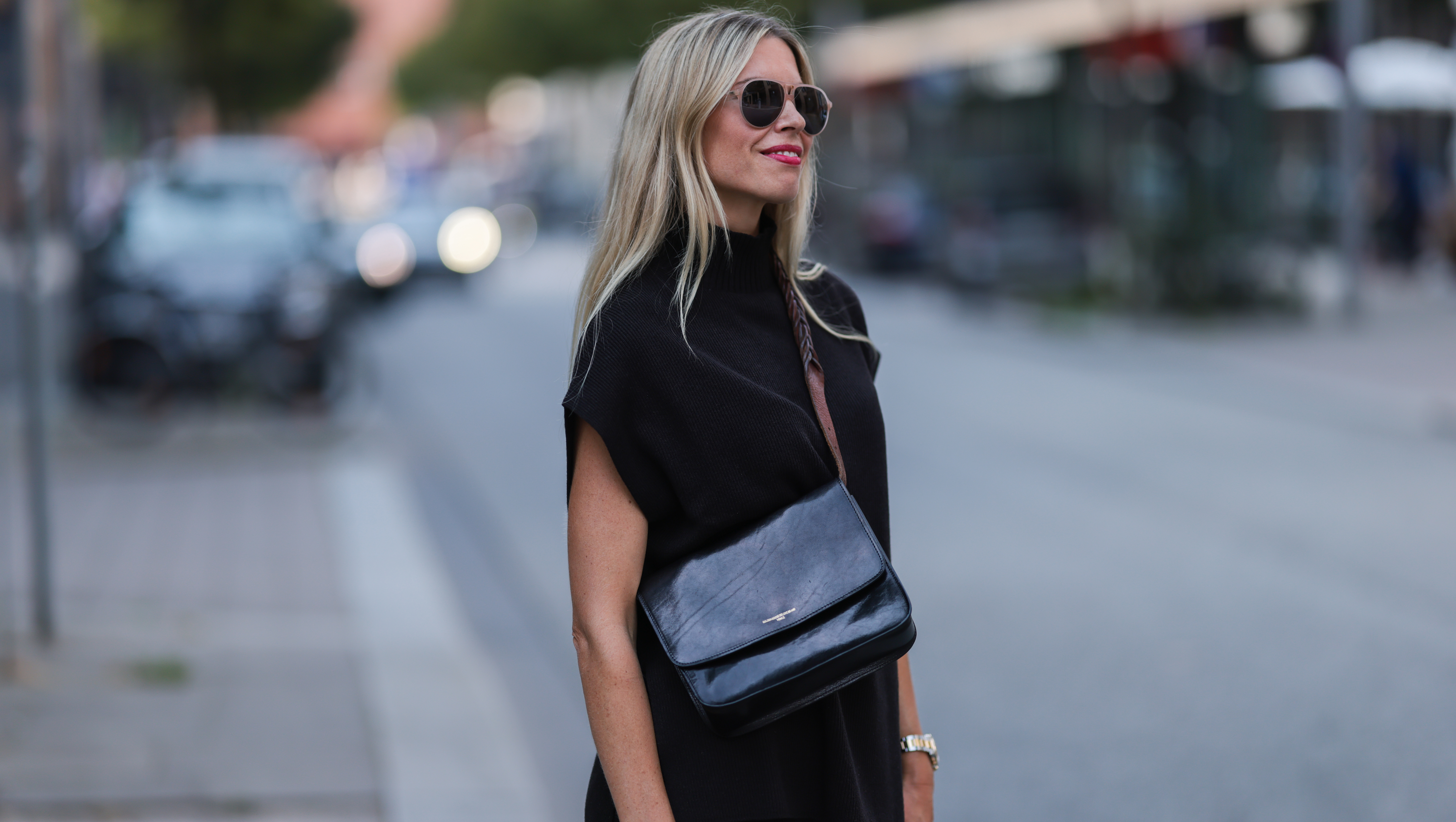 HAMBURG, GERMANY - AUGUST 15: Vanessa Gieser is seen wearing black Hermes Chypre sandals, Golden Goose small leather handbag, a SoSue black two-piece, a silver gold Rolex watch and sunglasses on August 15, 2022 in Hamburg, Germany. (Photo by Jeremy Moeller/Getty Images)