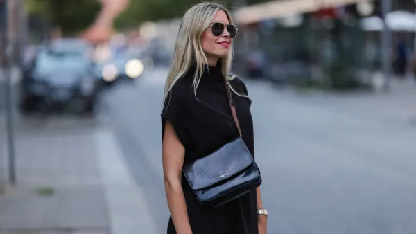 HAMBURG, GERMANY - AUGUST 15: Vanessa Gieser is seen wearing black Hermes Chypre sandals, Golden Goose small leather handbag, a SoSue black two-piece, a silver gold Rolex watch and sunglasses on August 15, 2022 in Hamburg, Germany. (Photo by Jeremy Moeller/Getty Images)