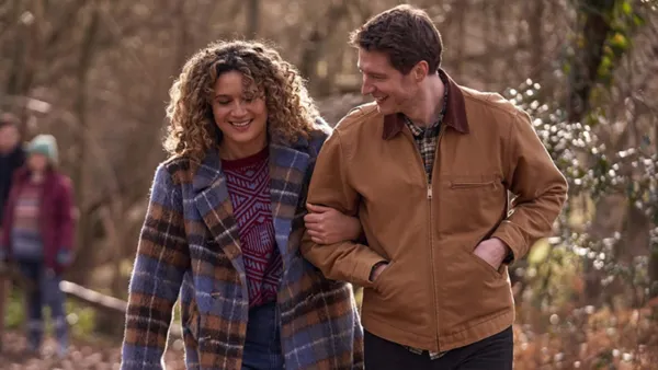 A woman walks with a man in 'Starstruck.'