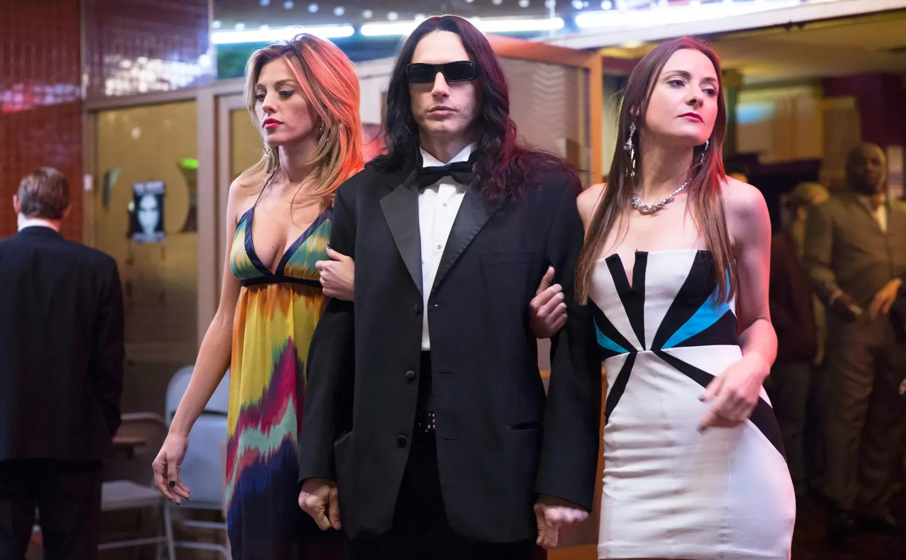 A man walks with two women in 'The Disaster Artist.'