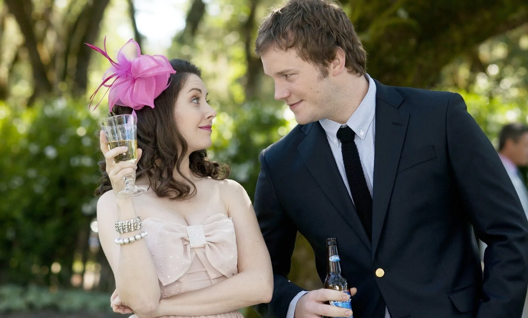 A man leans in to talk to a girl at a wedding in The Five-Year Engagement.