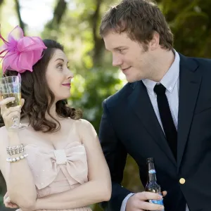 A man leans in to talk to a girl at a wedding in The Five-Year Engagement.