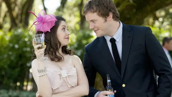 A man leans in to talk to a girl at a wedding in The Five-Year Engagement.