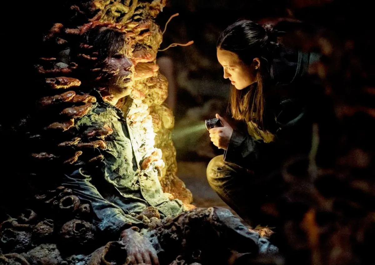 Ellie shines a flashlight on a monster in 'The Last of Us' season 2.