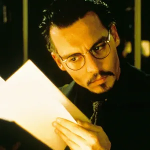 A man looks at a book in 'The Ninth Gate.'