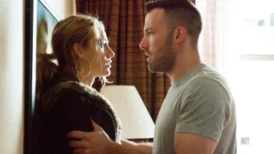 A man holds a woman in The Town.