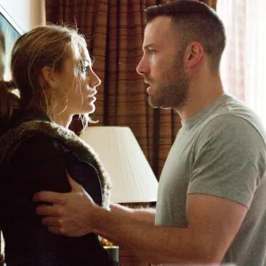 A man holds a woman in The Town.