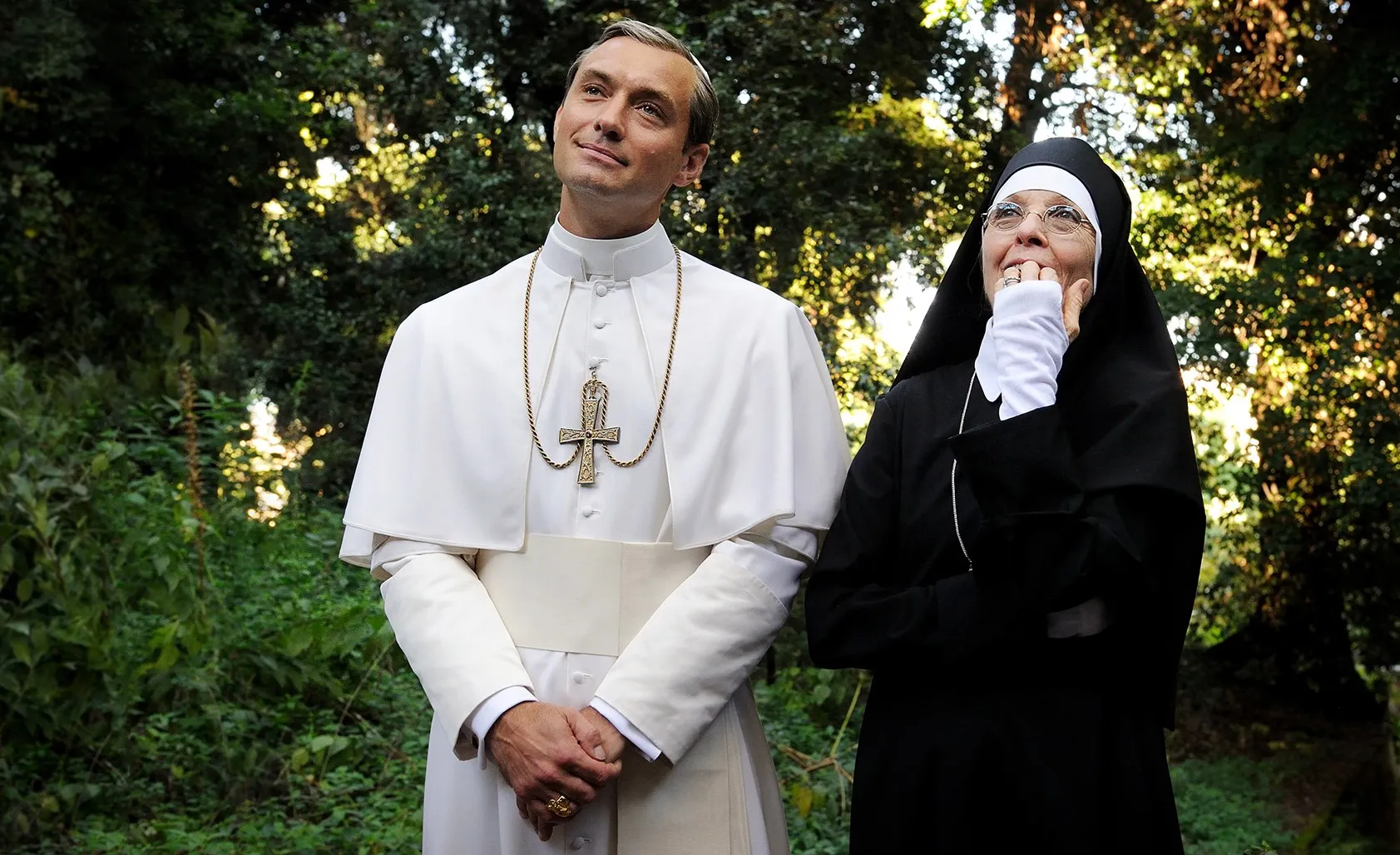 A pope and a num stand in a garden in 'The Young Pope.'