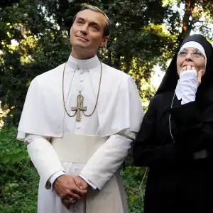 A pope and a num stand in a garden in 'The Young Pope.'