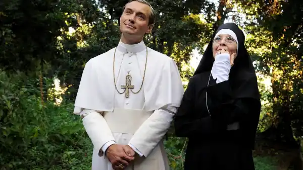 A pope and a num stand in a garden in 'The Young Pope.'